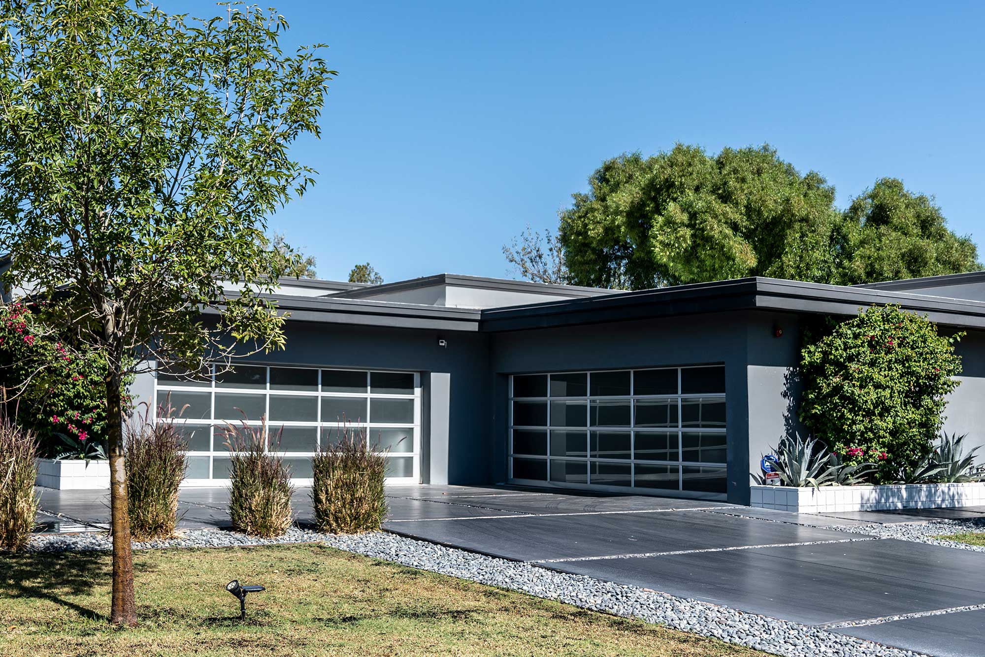 Modern Glass Garage Doors on a Luxury Modern Home in Marble Falls, Texas