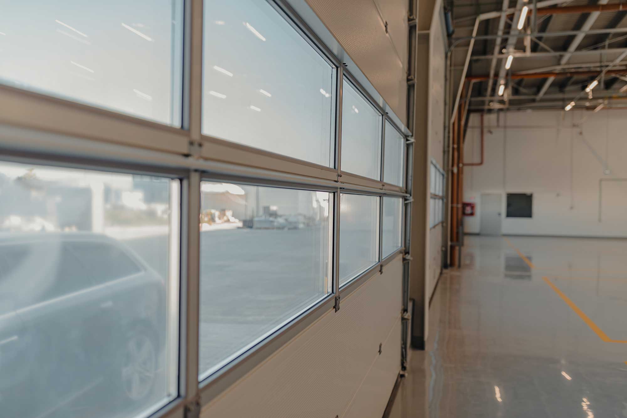 Inside view of a commercial car garage through garage doors Inside view of a commercial car garage through garage doors